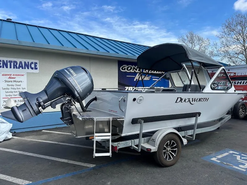 Slide: The Image of 2025 Duckworth 18 Advantage boat on trailer, parked outside a building. - 9