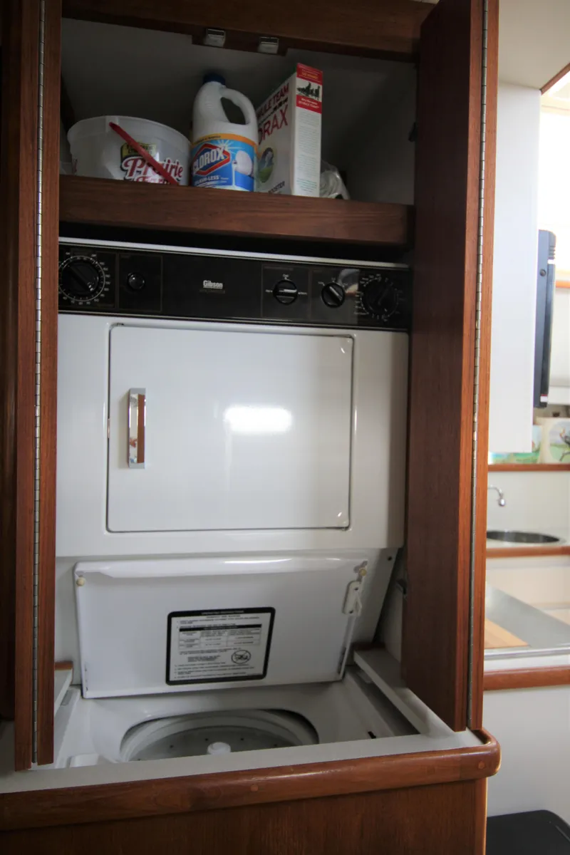 Slide: The Image of Washer Dryer Combo in Teak Closet - 12