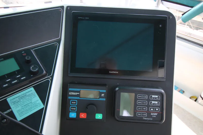 Slide: The Image of Control panel of a 1994 Carver 440 Aft Cabin Motor Yacht with navigation equipment. - 36