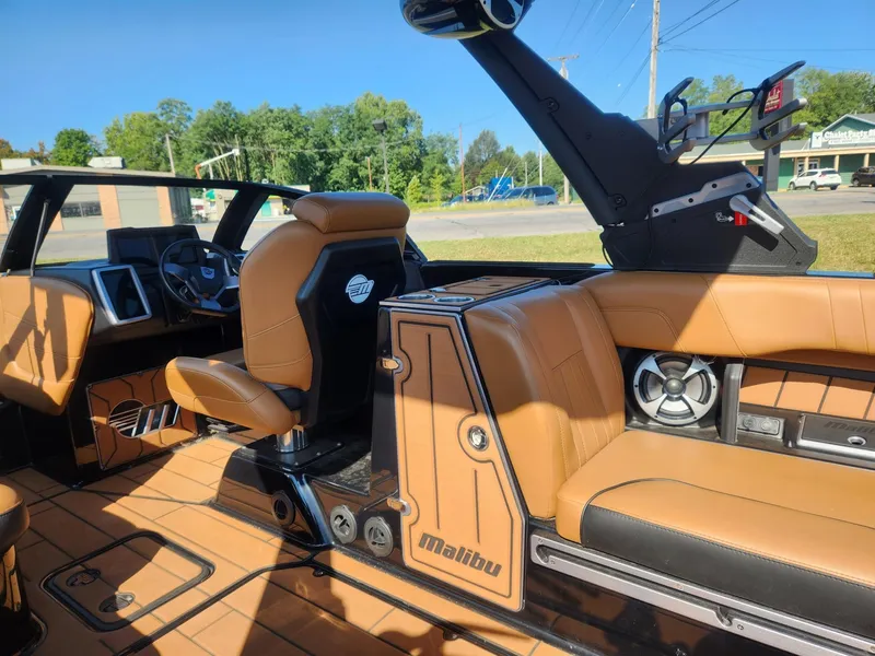 Slide: The Image of 2021 Malibu Wakesetter 24 MXZ interior with tan leather seats and modern dashboard. - 11