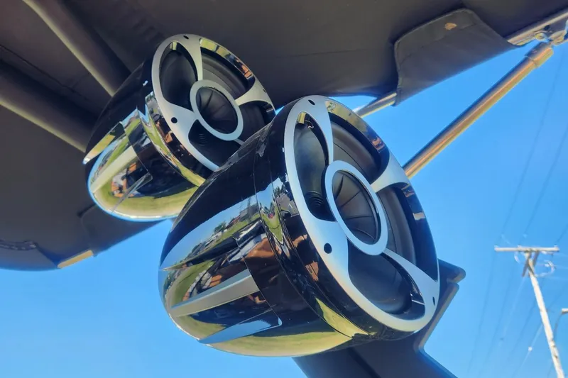 Slide: The Image of 2021 Malibu Wakesetter 24 MXZ boat speakers against clear blue sky. - 15