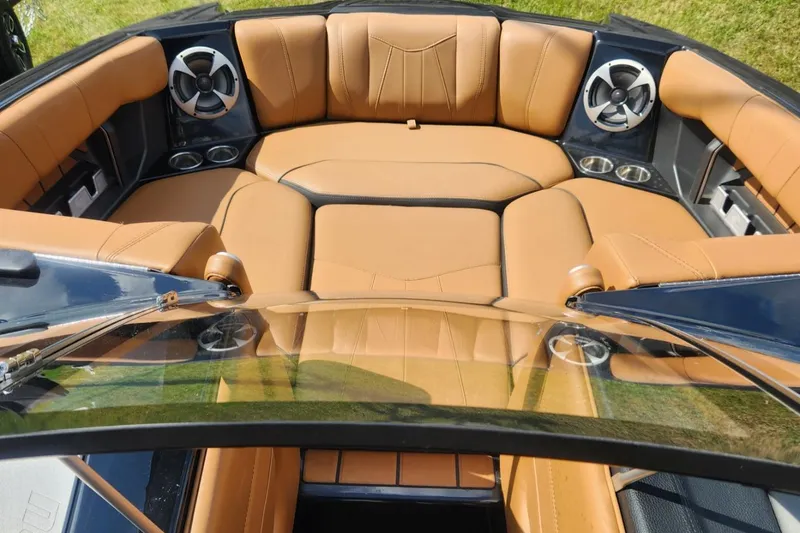 Slide: The Image of Luxurious interior of 2021 Malibu Wakesetter 24 MXZ with tan leather seating and cup holders. - 22