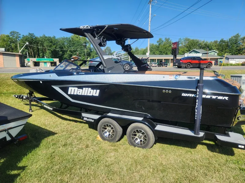 Slide: The Image of 2021 Malibu Wakesetter 24 MXZ boat on trailer, parked on grass. - 5