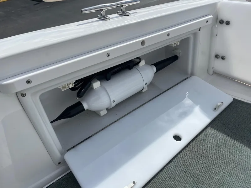 Slide: The Image of Storage compartment on a 2002 Cobalt 246 boat, featuring a neatly secured fender. - 17