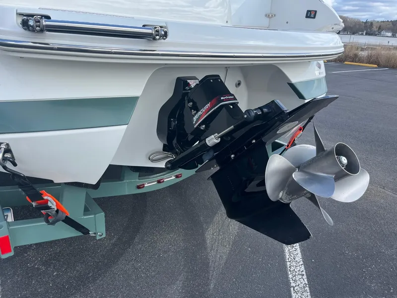 Slide: The Image of 2002 Cobalt 246 boat stern with Mercury outdrive and propeller in parking lot. - 4