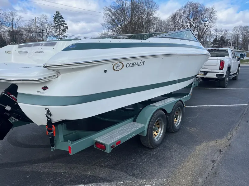 Slide: The Image of 2002 Cobalt 246 boat on trailer in parking lot, overcast sky. - 6