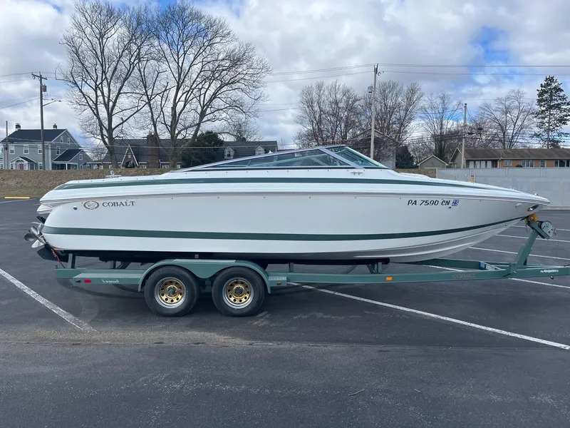 Slide: The Image of 2002 Cobalt 246 boat on trailer in parking lot, overcast sky. - 7