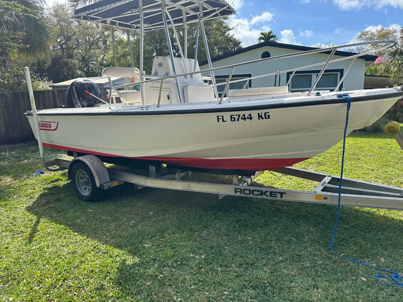 Slide: The Image of 1998 Boston Whaler Outrage 20 boat on trailer, parked on grass, sunny day. - 5