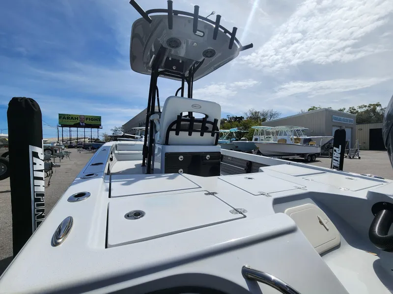 Slide: The Image of 2023 Pathfinder 2500 Hybrid boat with T-top, docked under a clear blue sky. - 10