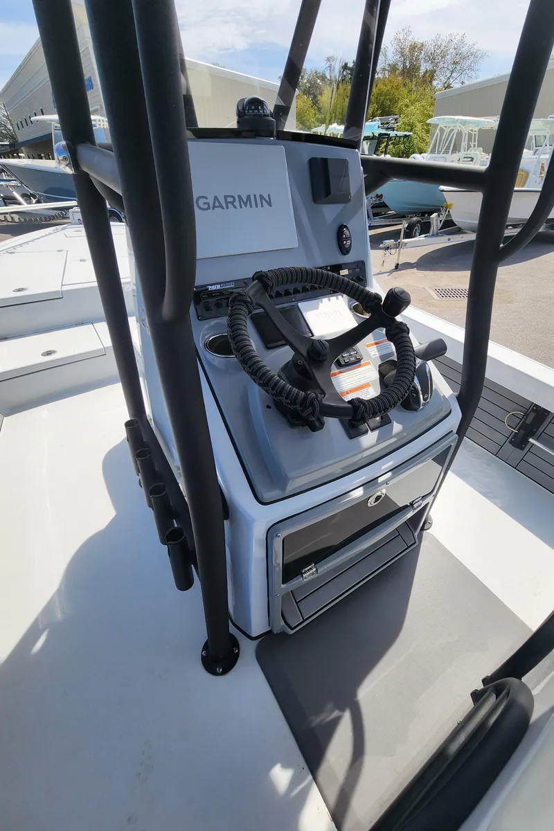 Slide: The Image of 2023 Pathfinder 2500 Hybrid boat console with Garmin equipment and storage compartments. - 18