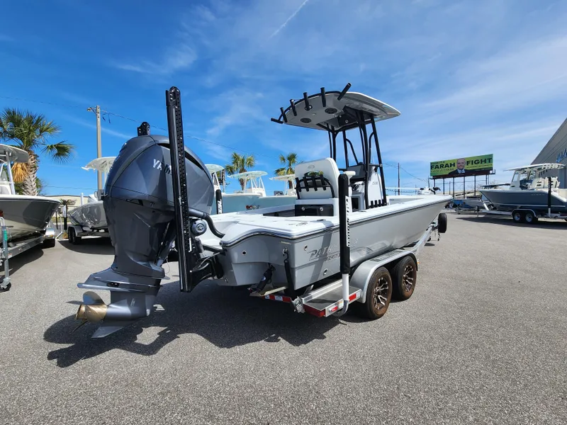 Slide: The Image of 2023 Pathfinder 2500 Hybrid boat with Yamaha engine, parked on a trailer under a clear blue sky. - 2