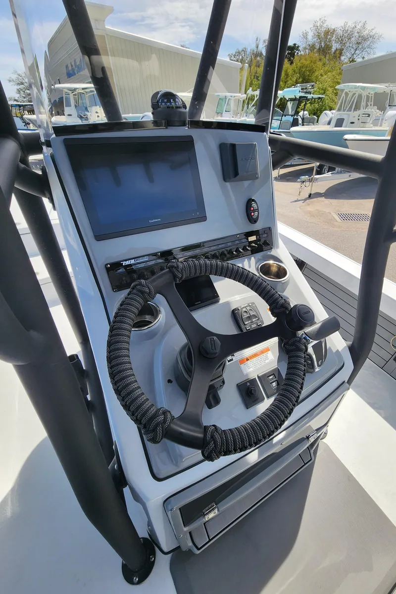 Slide: The Image of 2023 Pathfinder 2500 Hybrid boat console with steering wheel and navigation display. - 21