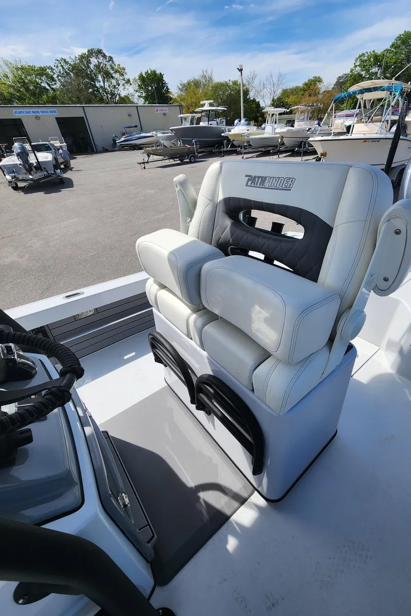 Slide: The Image of 2023 Pathfinder 2500 Hybrid boat seat in a marina setting. - 22