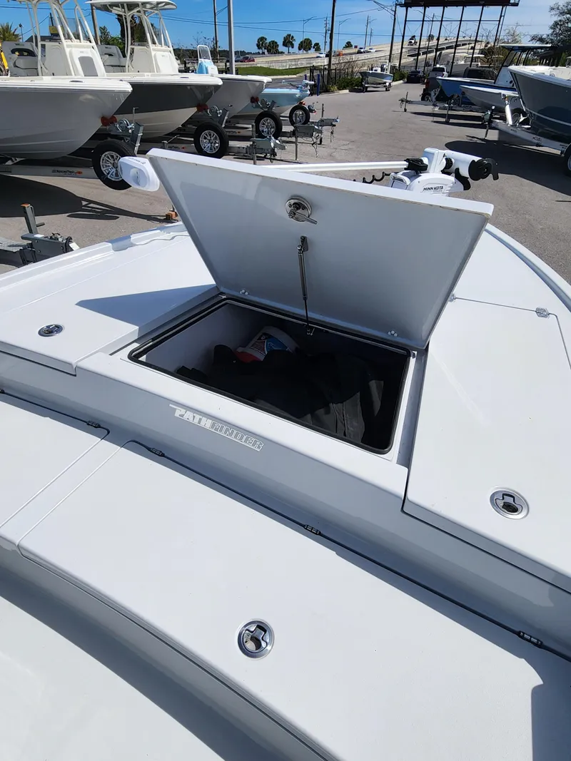 Slide: The Image of 2023 Pathfinder 2500 Hybrid boat with open storage compartment, displayed outdoors. - 27