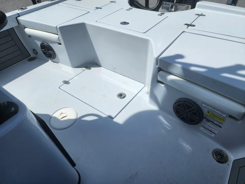 Slide: The Image of 2023 Pathfinder 2500 Hybrid boat interior with storage compartments and speakers. - 28