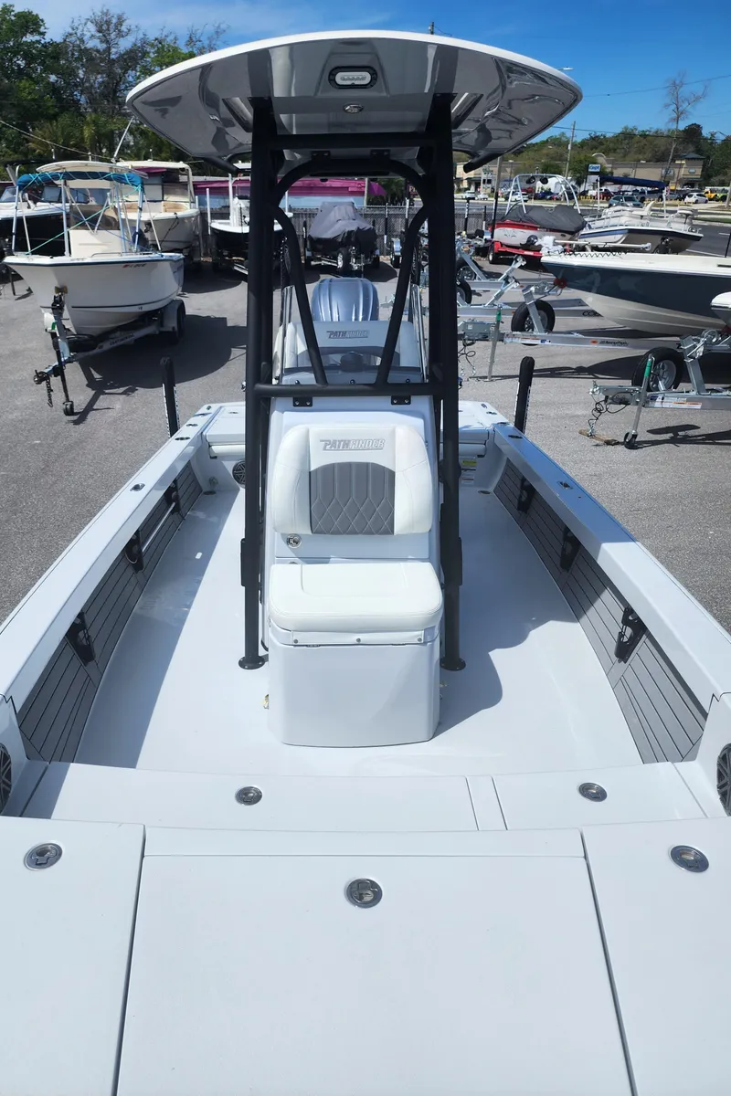 Slide: The Image of 2023 Pathfinder 2500 Hybrid boat, sleek design, docked among other boats. - 36