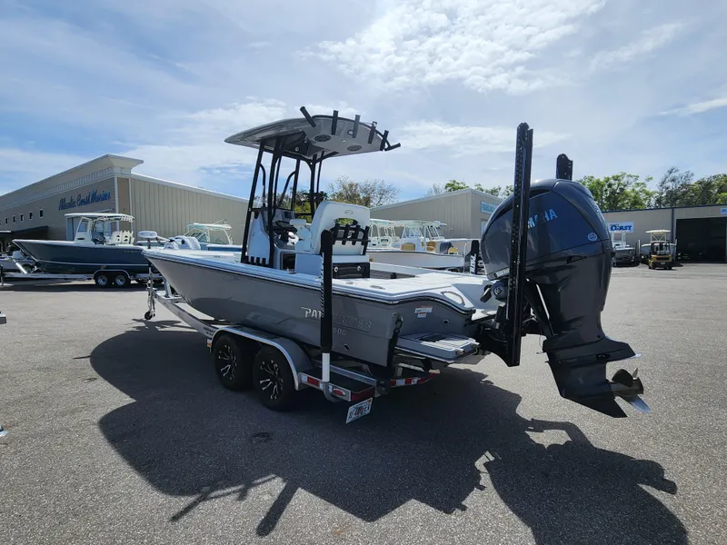 Slide: The Image of 2023 Pathfinder 2500 Hybrid boat on trailer, parked outdoors under a cloudy sky. - 4