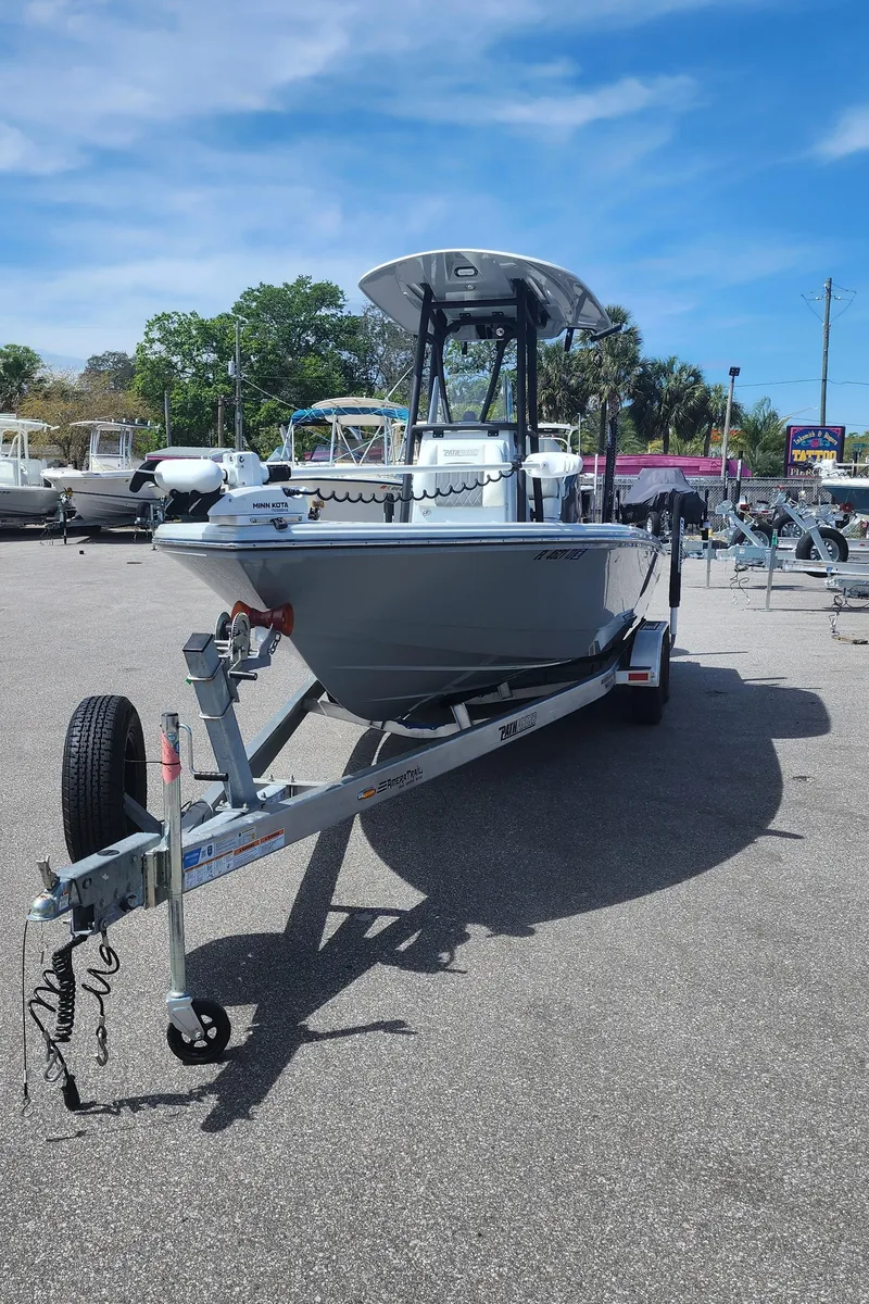 Slide: The Image of 2023 Pathfinder 2500 Hybrid boat on trailer under clear blue sky. - 7