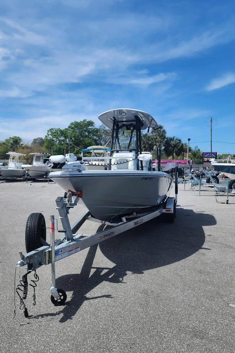 Slide: The Image of 2023 Pathfinder 2500 Hybrid boat on trailer under clear blue sky. - 8
