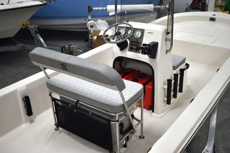 Slide: The Image of 2025 Carolina Skiff E20 JVX Center Console boat interior with seating and steering wheel. - 10