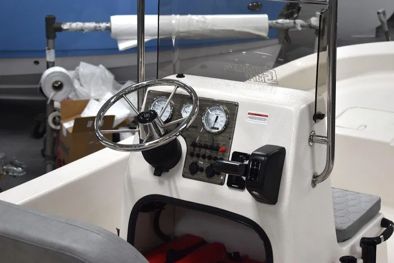 Slide: The Image of 2025 Carolina Skiff E20 JVX Center Console dashboard with steering wheel and gauges. - 11