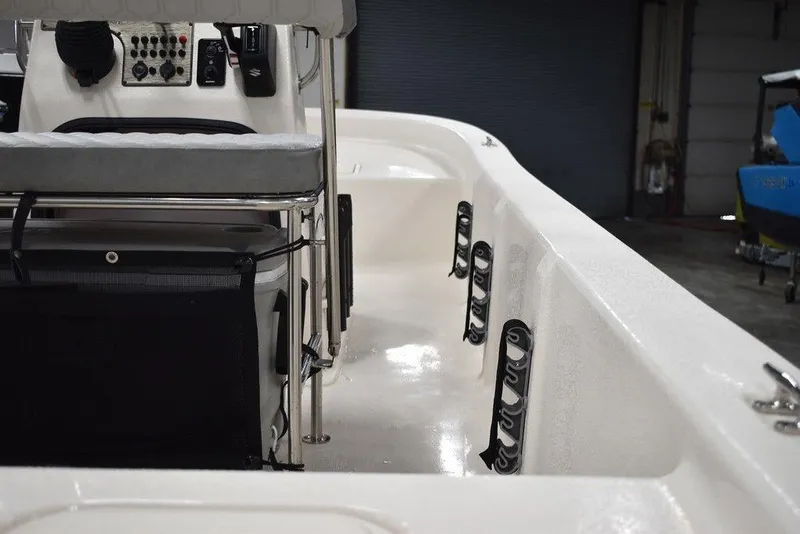 Slide: The Image of 2025 Carolina Skiff E20 JVX Center Console interior with seating and rod holders. - 14