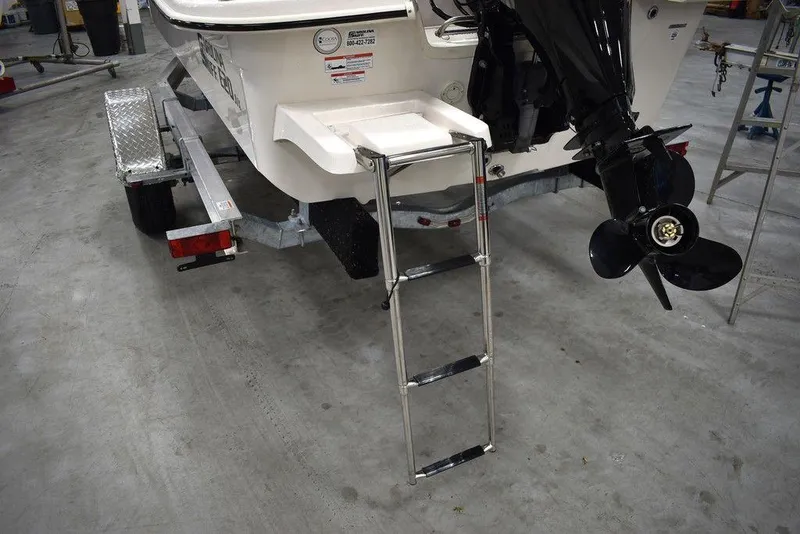 Slide: The Image of 2025 Carolina Skiff E20 JVX Center Console with ladder and trailer in a garage. - 15