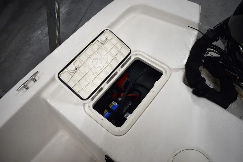 Slide: The Image of 2025 Carolina Skiff E20 JVX Center Console storage compartment with open hatch. - 17