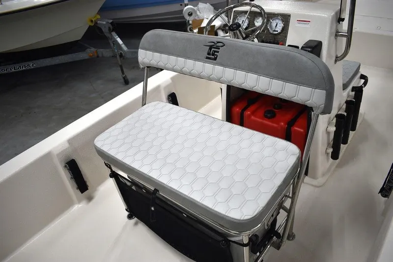 Slide: The Image of 2025 Carolina Skiff E20 JVX Center Console interior with cushioned seating and steering console. - 19