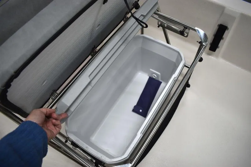 Slide: The Image of 2025 Carolina Skiff E20 JVX Center Console storage compartment with open lid. - 21