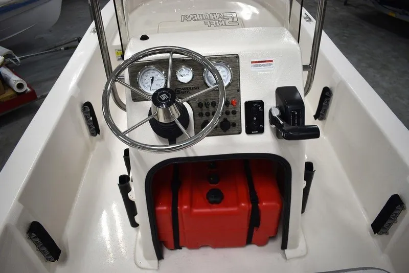 Slide: The Image of 2025 Carolina Skiff E20 JVX Center Console with steering wheel and gauges. - 24