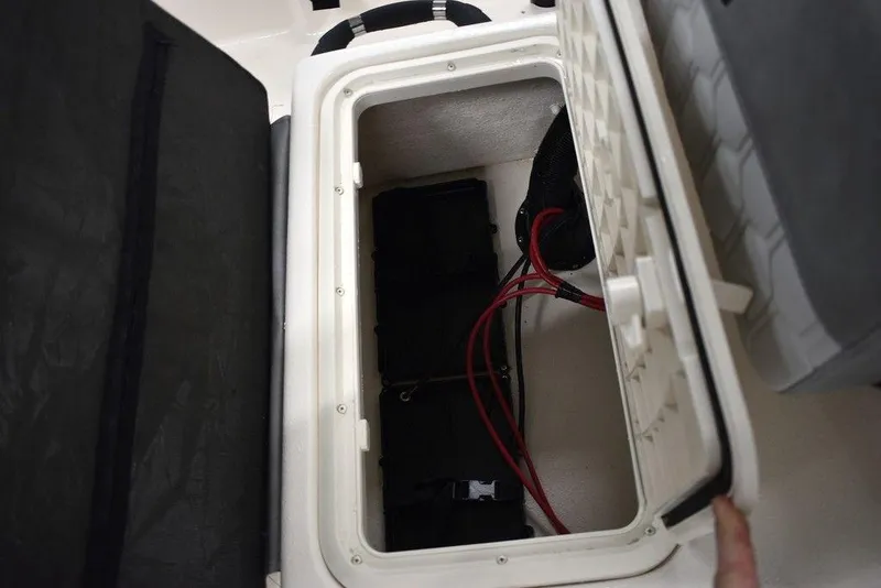 Slide: The Image of 2025 Carolina Skiff E20 JVX Center Console battery compartment with wiring. - 29