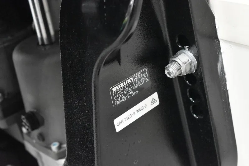 Slide: The Image of Close-up of a Suzuki engine part on a 2025 Carolina Skiff E20 JVX Center Console boat. - 36
