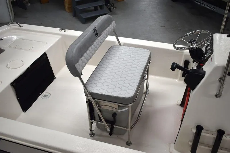 Slide: The Image of 2025 Carolina Skiff E20 JVX Center Console interior with seating and steering wheel. - 8