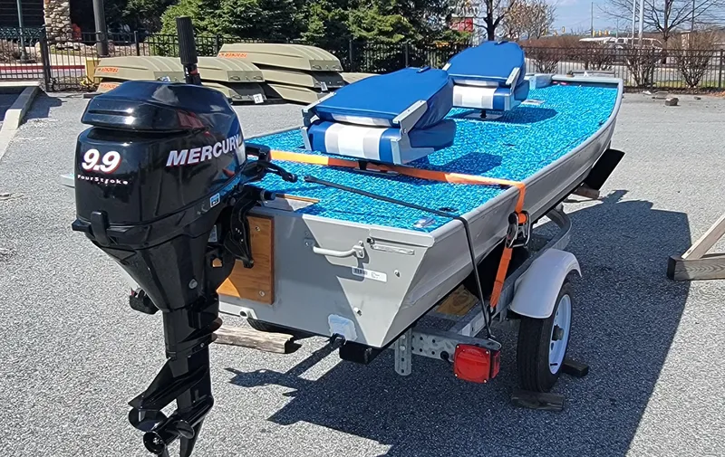 Slide: The Image of 2011 Tracker Topper 1436 Riveted Jon boat with Mercury 9.9 motor on trailer. - 5