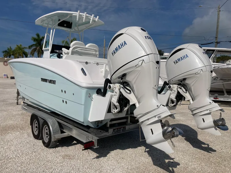 Slide: The Image of 2025 Twin Vee 240GFX boat with dual Yamaha 150 engines on a trailer. - 4