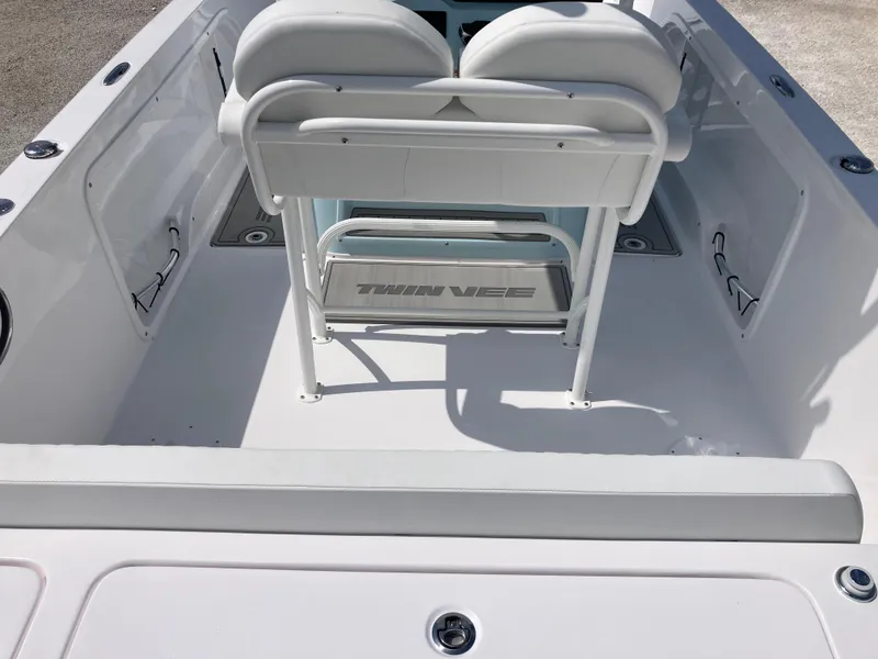 Slide: The Image of 2025 Twin Vee 240GFX boat interior with white seating and clean deck design. - 6