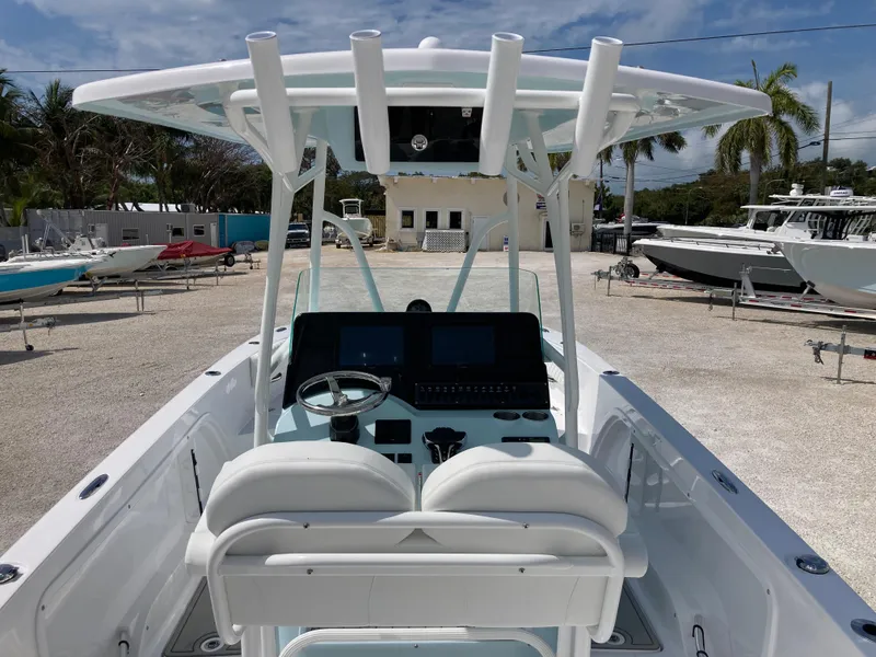 Slide: The Image of 2025 Twin Vee 240GFX boat interior with helm, dual seats, and modern controls. - 7