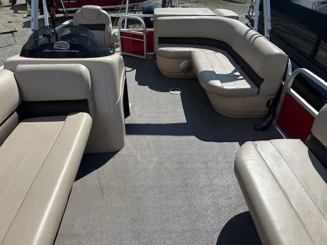 Slide: The Image of 2017 Sun Tracker Party Barge 20 DLX interior with beige seating and spacious layout. - 13