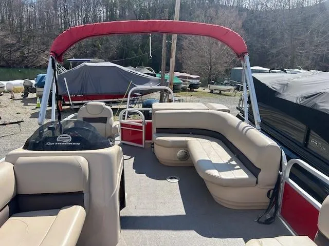 Slide: The Image of 2017 Sun Tracker Party Barge 20 DLX pontoon boat with red canopy and beige seating. - 14