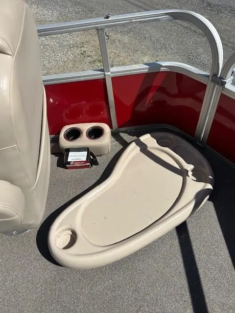 Slide: The Image of 2017 Sun Tracker Party Barge 20 DLX interior with beige seating and cup holders. - 17