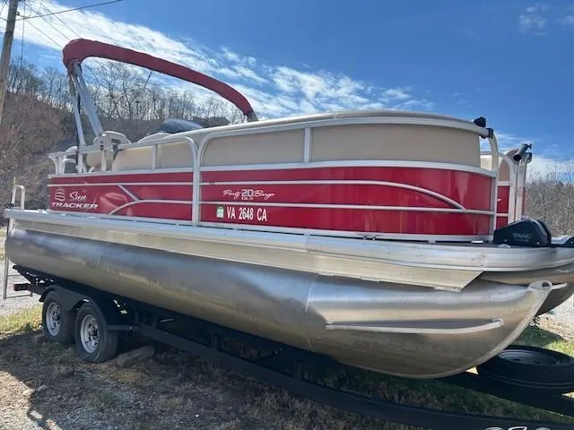 Slide: The Image of 2017 Sun Tracker Party Barge 20 DLX pontoon boat on trailer, red and beige design. - 4