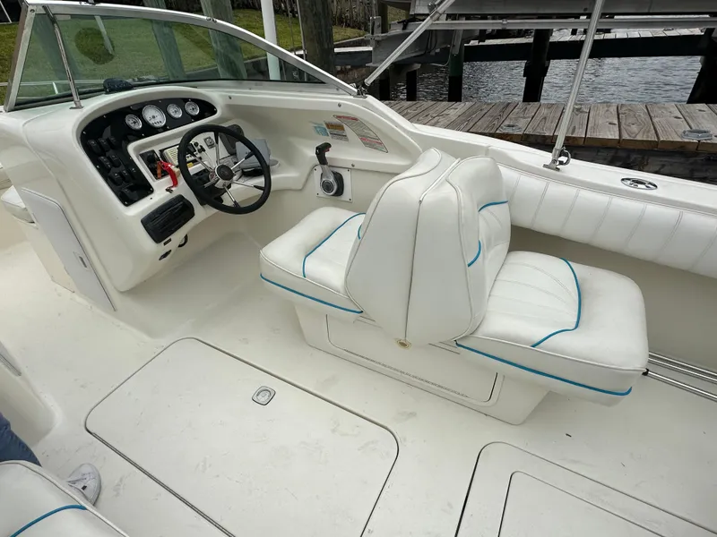 Slide: The Image of 1997 Sea Ray Laguna 21 boat interior with white seating and control panel. - 10