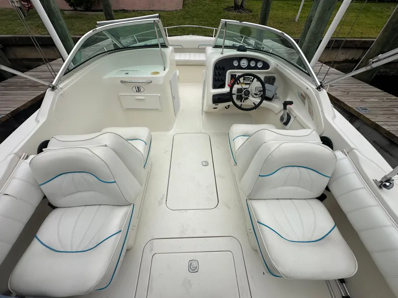 Slide: The Image of 1997 Sea Ray Laguna 21 boat interior with white seating and steering console. - 11