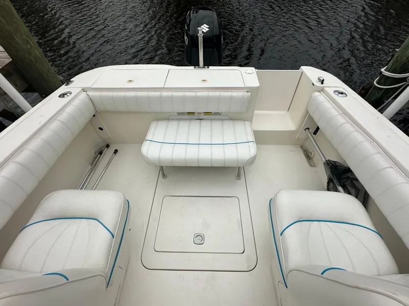 Slide: The Image of 1997 Sea Ray Laguna 21 boat interior with white seating and outboard motor. - 16
