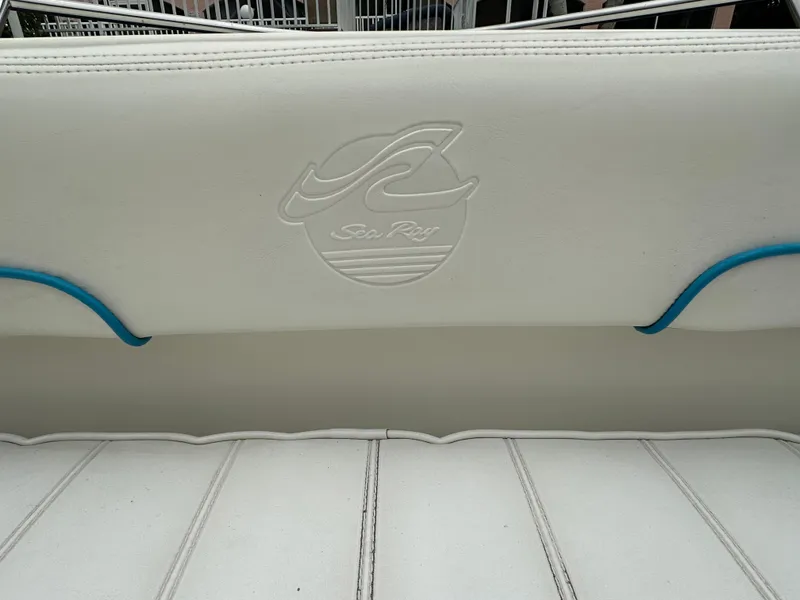 Slide: The Image of 1997 Sea Ray Laguna 21 boat seat with embossed logo and blue accents. - 17