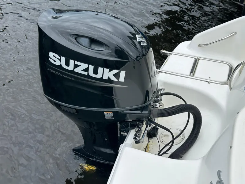 Slide: The Image of Suzuki outboard motor on 1997 Sea Ray Laguna 21 boat in water. - 18