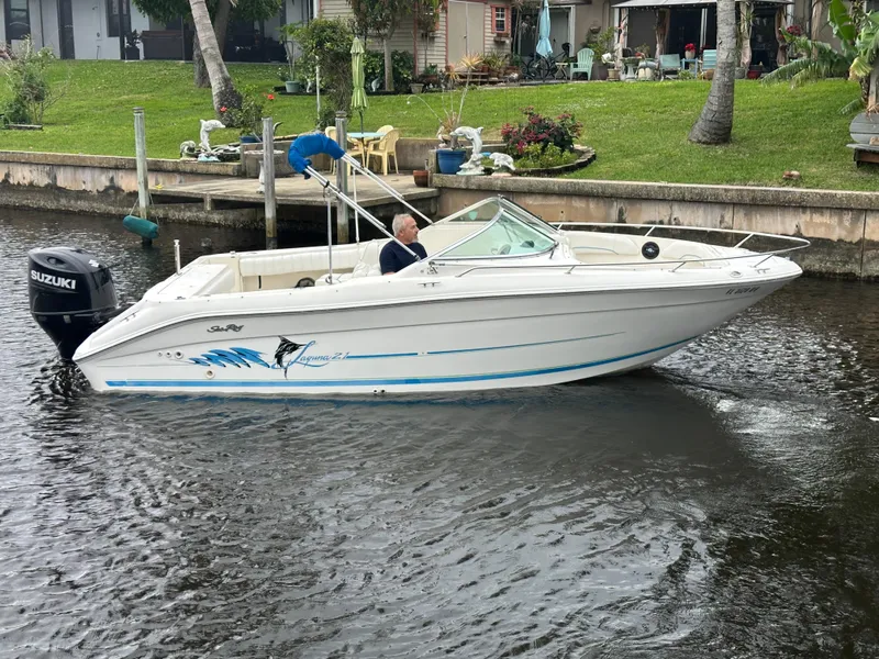 Slide: The Image of 1997 Sea Ray Laguna 21 boat with Suzuki outboard motor on a calm canal. - 2