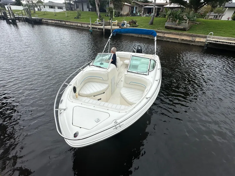Slide: The Image of 1997 Sea Ray Laguna 21 boat with blue canopy on a calm canal. - 6