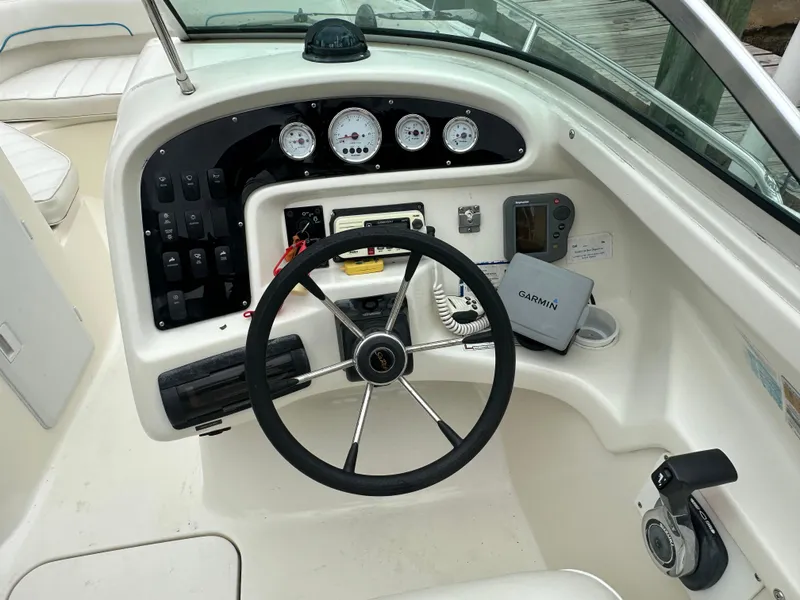 Slide: The Image of 1997 Sea Ray Laguna 21 boat dashboard with steering wheel and navigation instruments. - 8